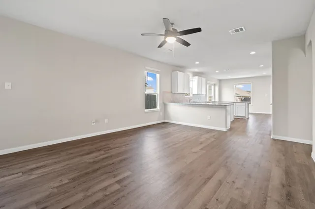 a view of a kitchen with wooden floor a sink and dishwasher