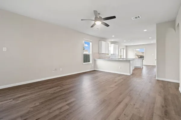 a view of a kitchen with wooden floor a sink and dishwasher
