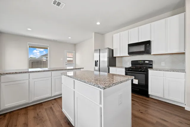 a kitchen with a sink stove and refrigerator