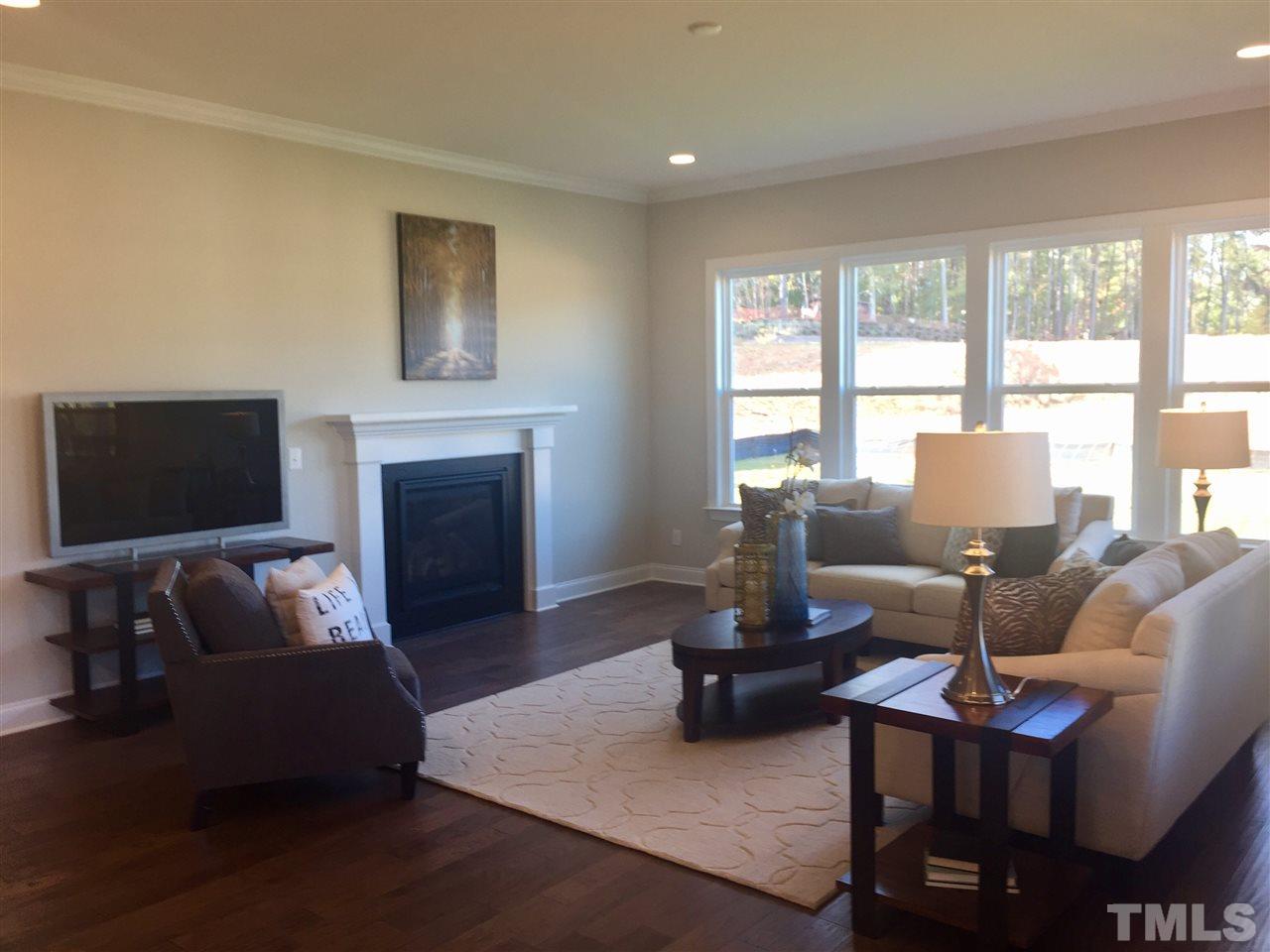 5264 Aleppo Lane, Unit 51 Raleigh, NC 27613 - Photo 11 of 22 a living room with furniture a large window and a flat screen tv