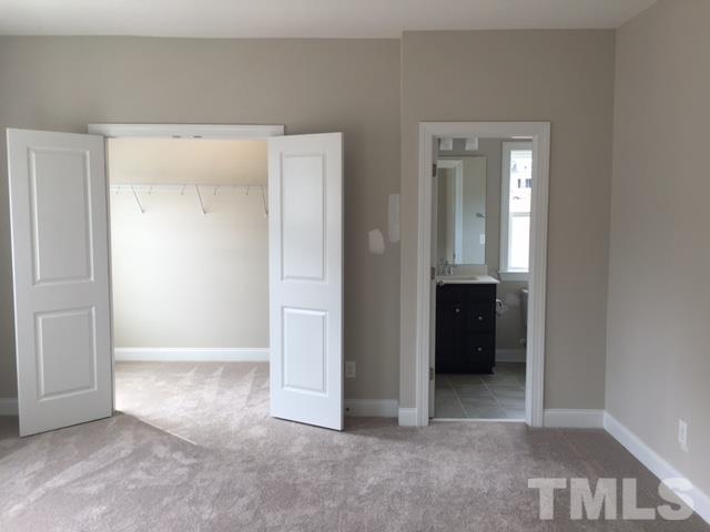 5264 Aleppo Lane, Unit 51 Raleigh, NC 27613 - Photo 13 of 22 an empty room with closet and a bathroom