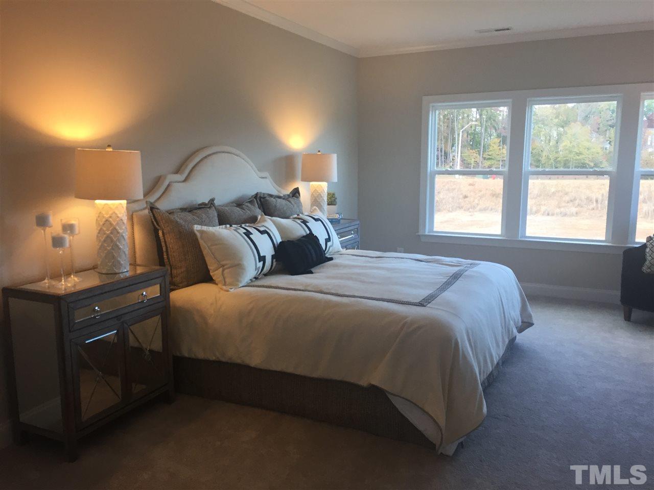 5264 Aleppo Lane, Unit 51 Raleigh, NC 27613 - Photo 14 of 22 a bedroom with a bed and a lamp