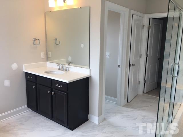 5264 Aleppo Lane, Unit 51 Raleigh, NC 27613 - Photo 16 of 22 a bathroom with a sink vanity and mirror