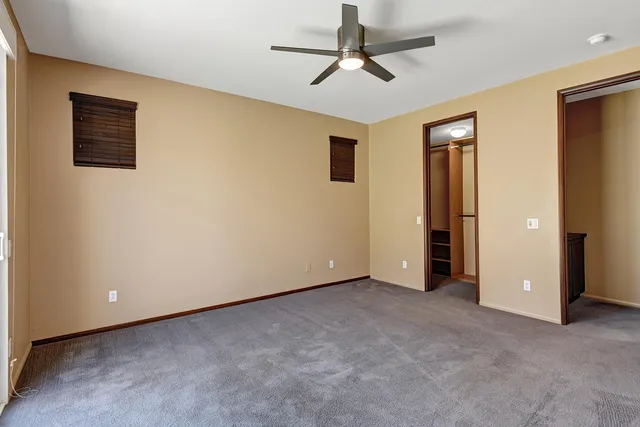 a view of an empty room with a ceiling fan