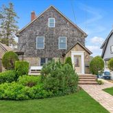 a view of a house with a yard and plants