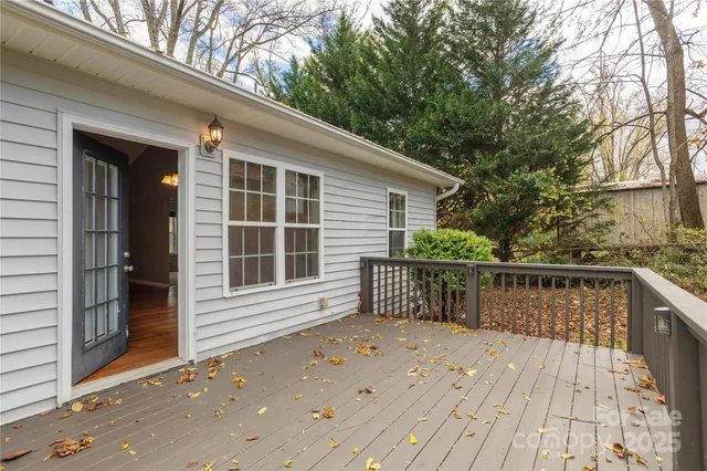 a balcony with wooden floor and fence
