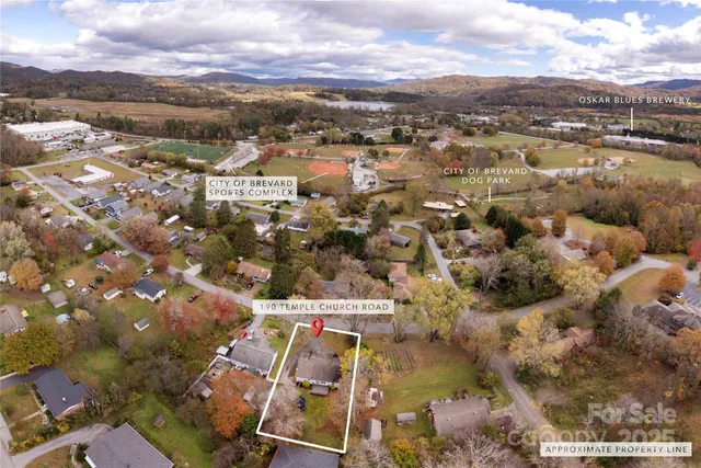 an aerial view of residential houses with city view
