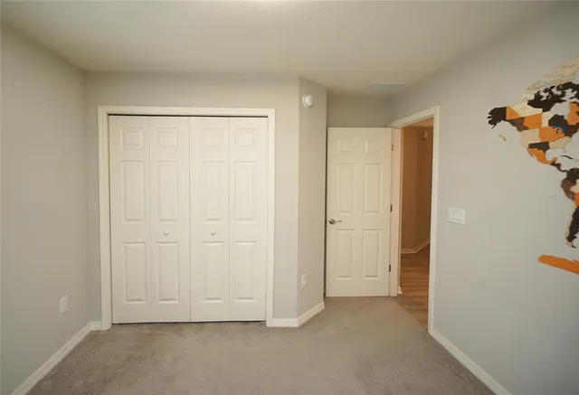 an empty room with closet area