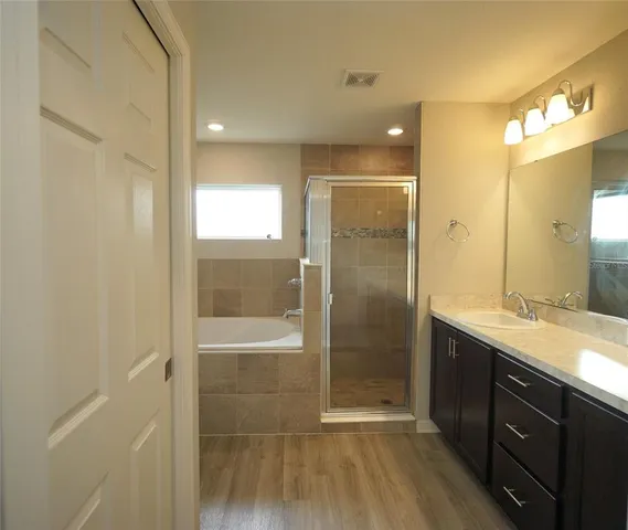 a bathroom with a shower sink and mirror