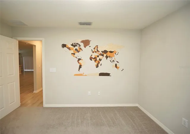 an white room with a refrigerator