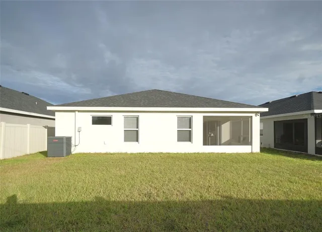 a large white house with yard in front of it