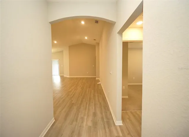 a view of a hallway with wooden floor