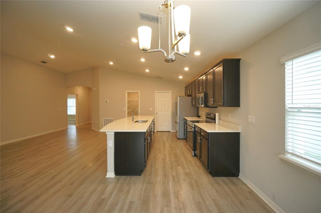 12221 Cypress Br Street Riverview, FL 33579 - Photo 6 of 20 a kitchen with stainless steel appliances granite countertop a sink a stove and a wooden floors