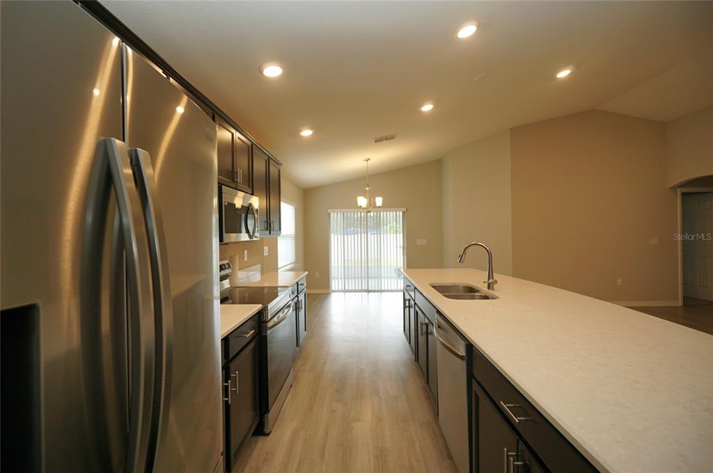 12221 Cypress Br Street Riverview, FL 33579 - Photo 7 of 20 a kitchen with stainless steel appliances granite countertop sink stove refrigerator and cabinets