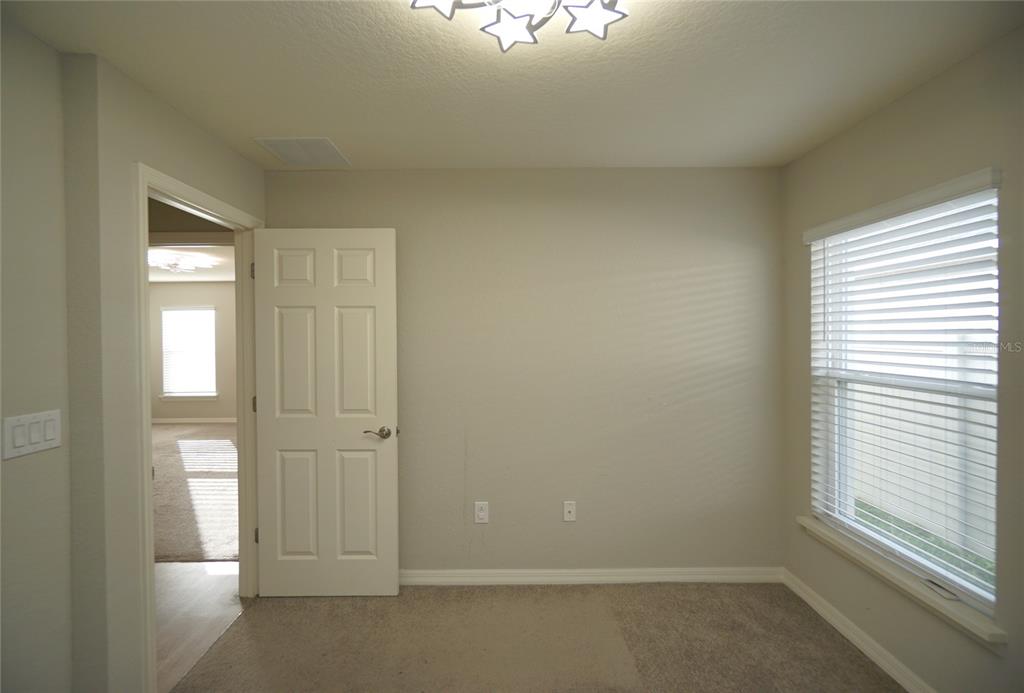 12221 Cypress Br Street Riverview, FL 33579 - Photo 9 of 20 an empty room that has a window
