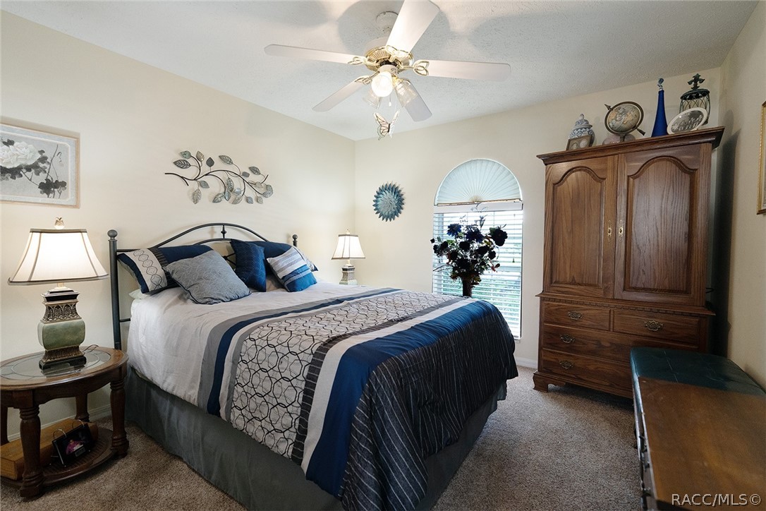 800 Balmoral Court Inverness, FL 34453 - Photo 33 of 72 a bedroom with a bed and a chandelier