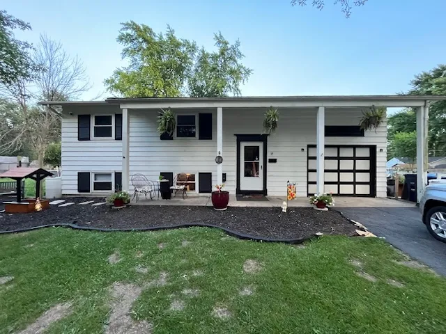 a view of a house with a yard and patio