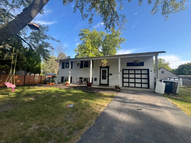 a view of a house with swimming pool and sitting area