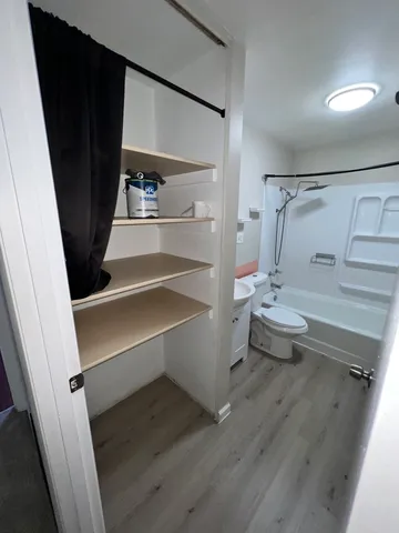 a view of walk in closet with empty racks