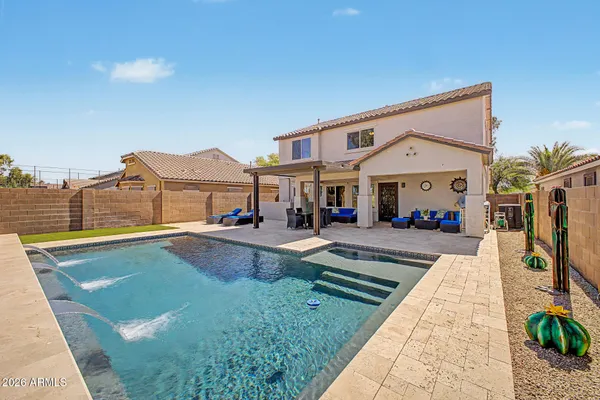 a view of a house with swimming pool and a porch