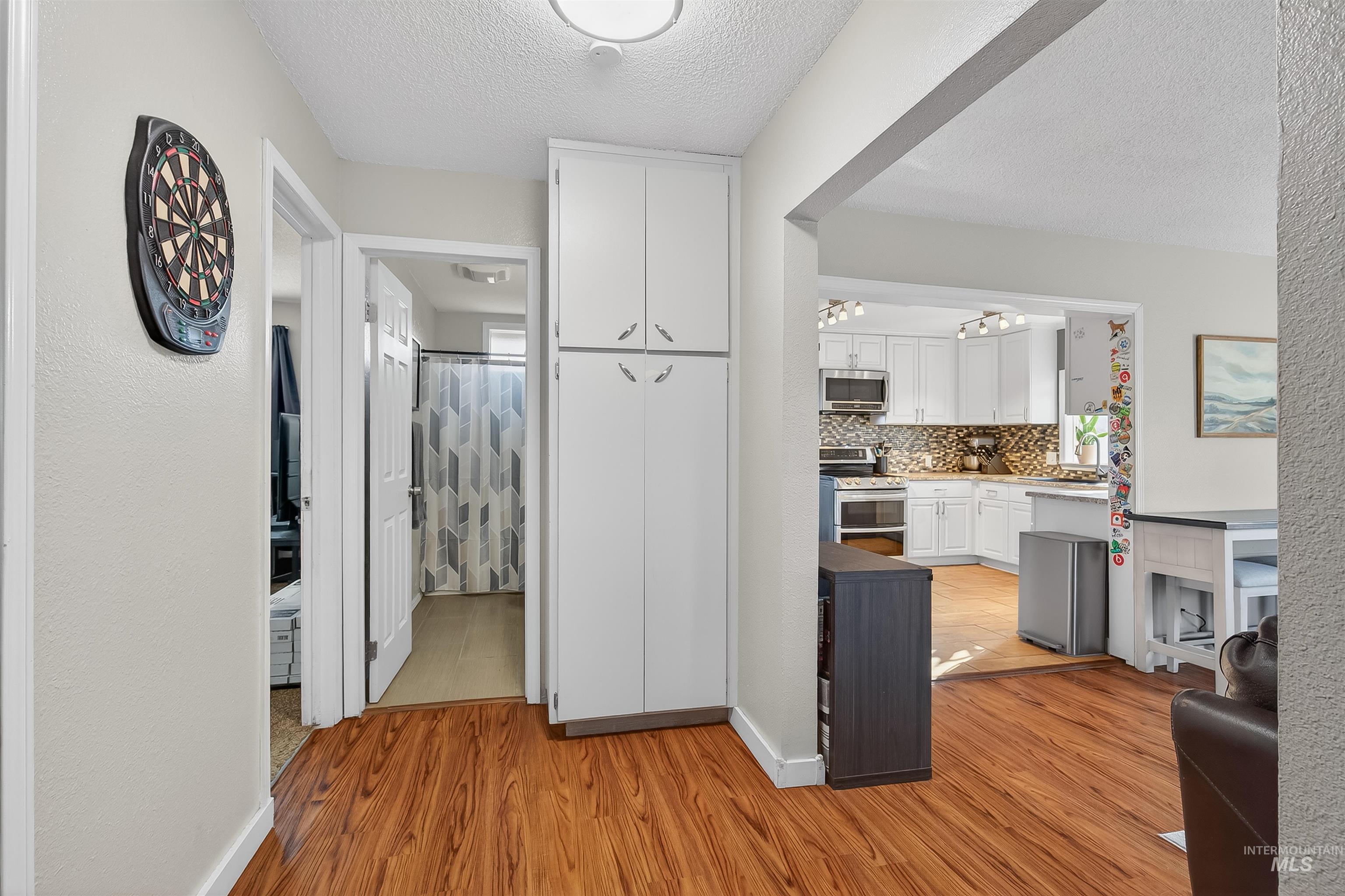 807 3rd Street Clarkston, WA 99403 - Photo 17 of 33 Hall featuring a textured ceiling, light wood-style floors, and a textured wall