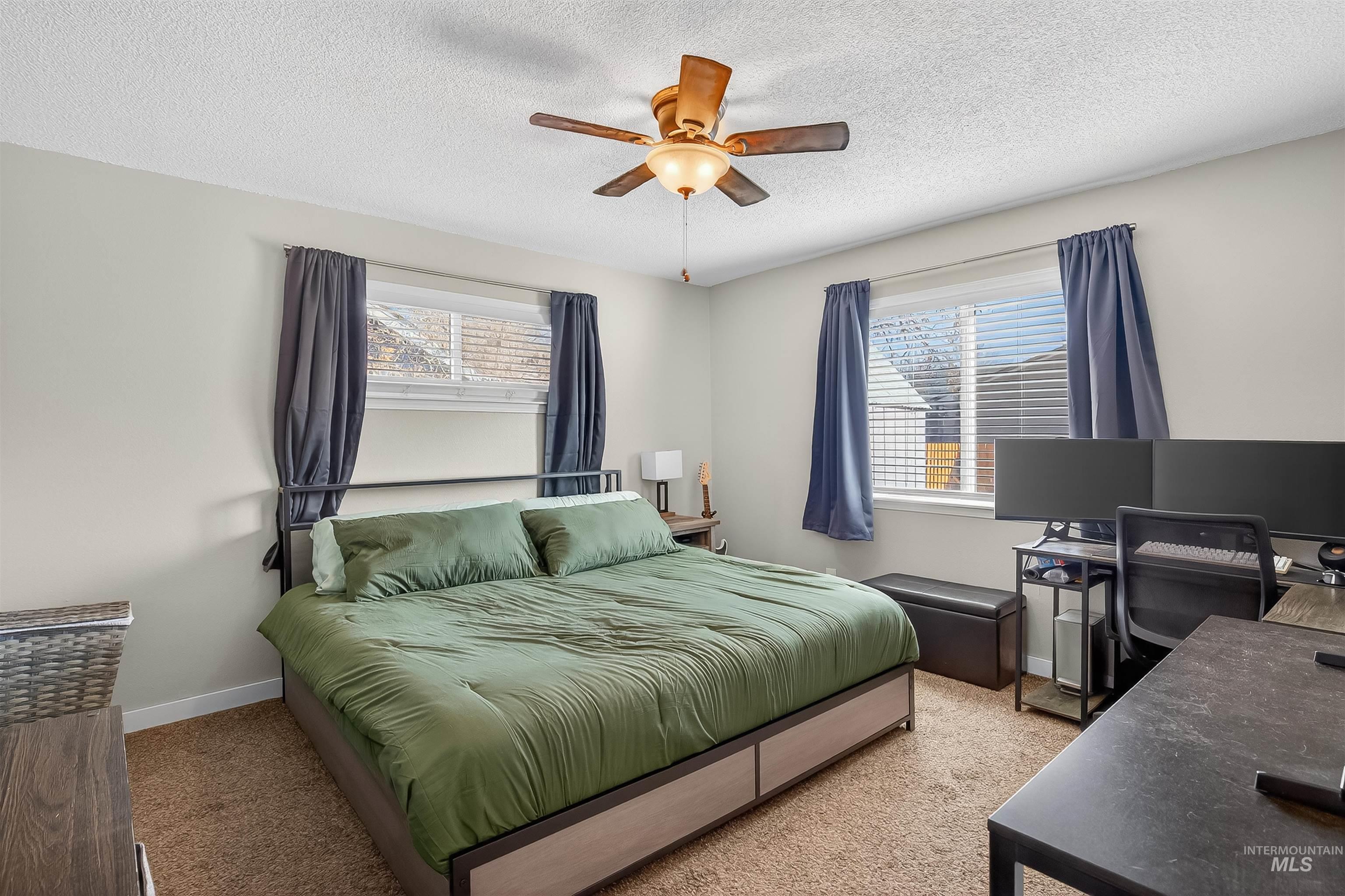 807 3rd Street Clarkston, WA 99403 - Photo 18 of 33 Carpeted bedroom featuring a desk, ceiling fan, and a textured ceiling