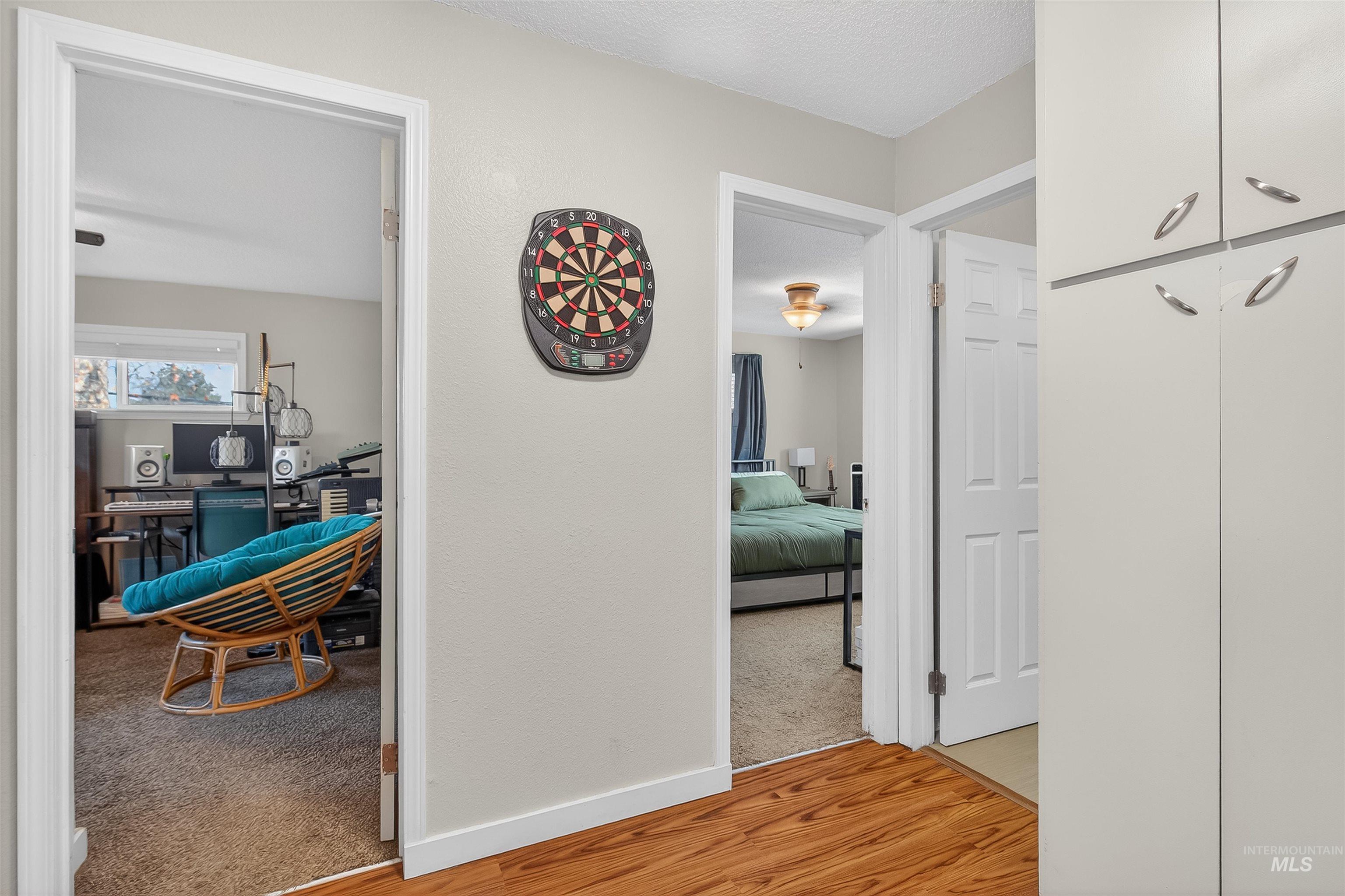 807 3rd Street Clarkston, WA 99403 - Photo 20 of 33 Hall with light wood-style flooring, light carpet, and a textured ceiling