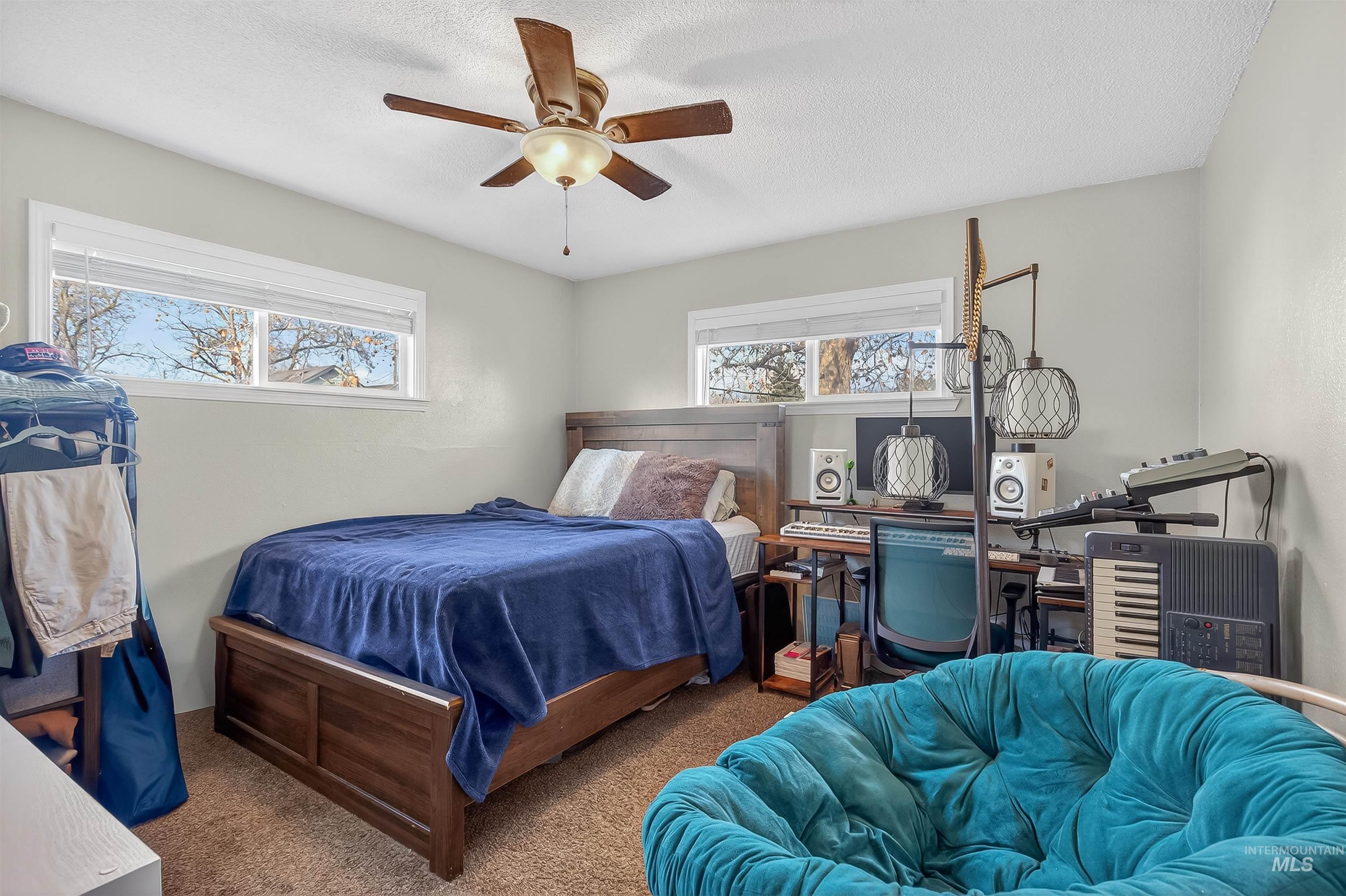807 3rd Street Clarkston, WA 99403 - Photo 21 of 33 Carpeted bedroom featuring ceiling fan and a textured ceiling