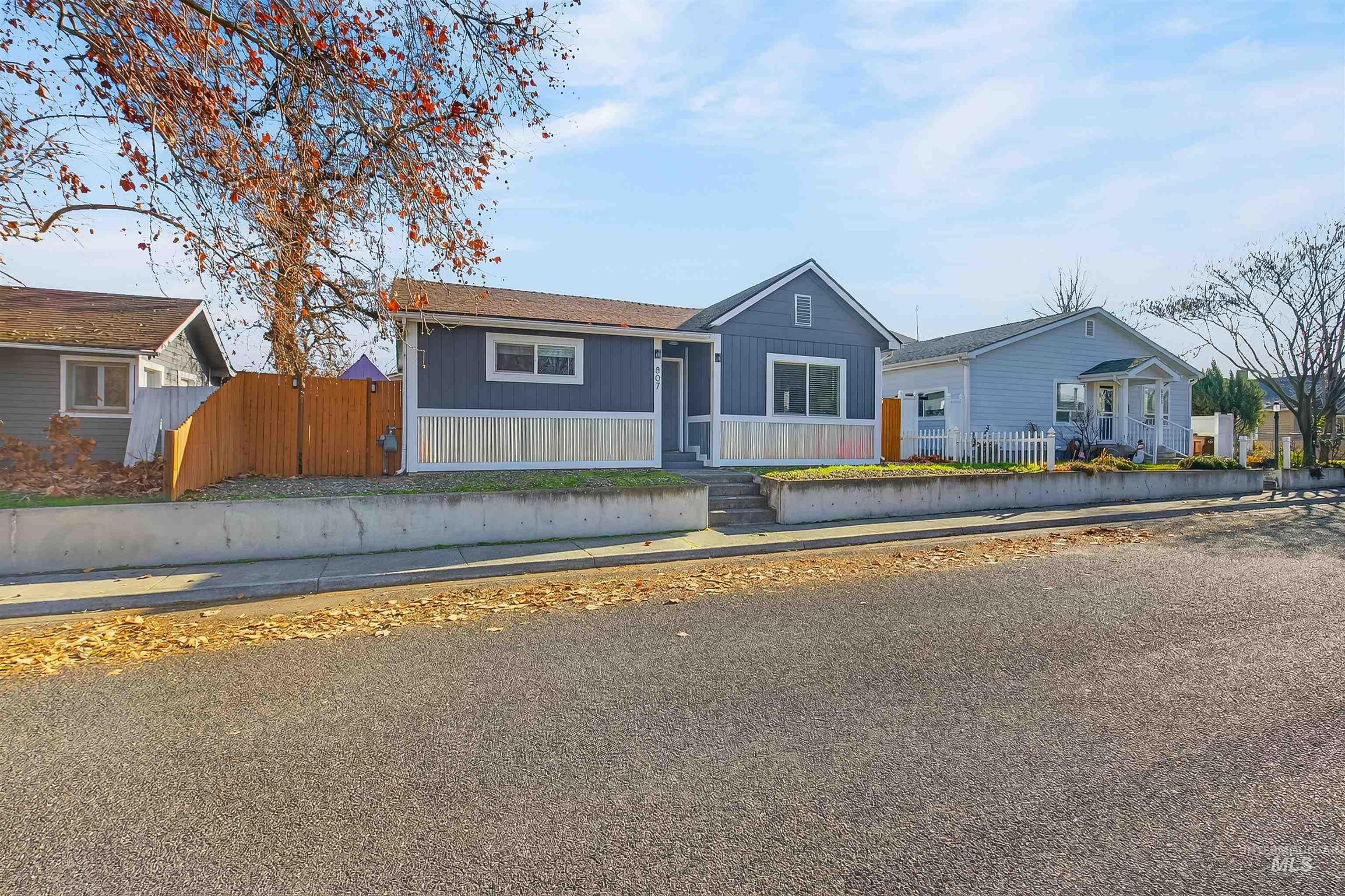 807 3rd Street Clarkston, WA 99403 - Photo 25 of 33 View of front of home with a fenced front yard and board and batten siding