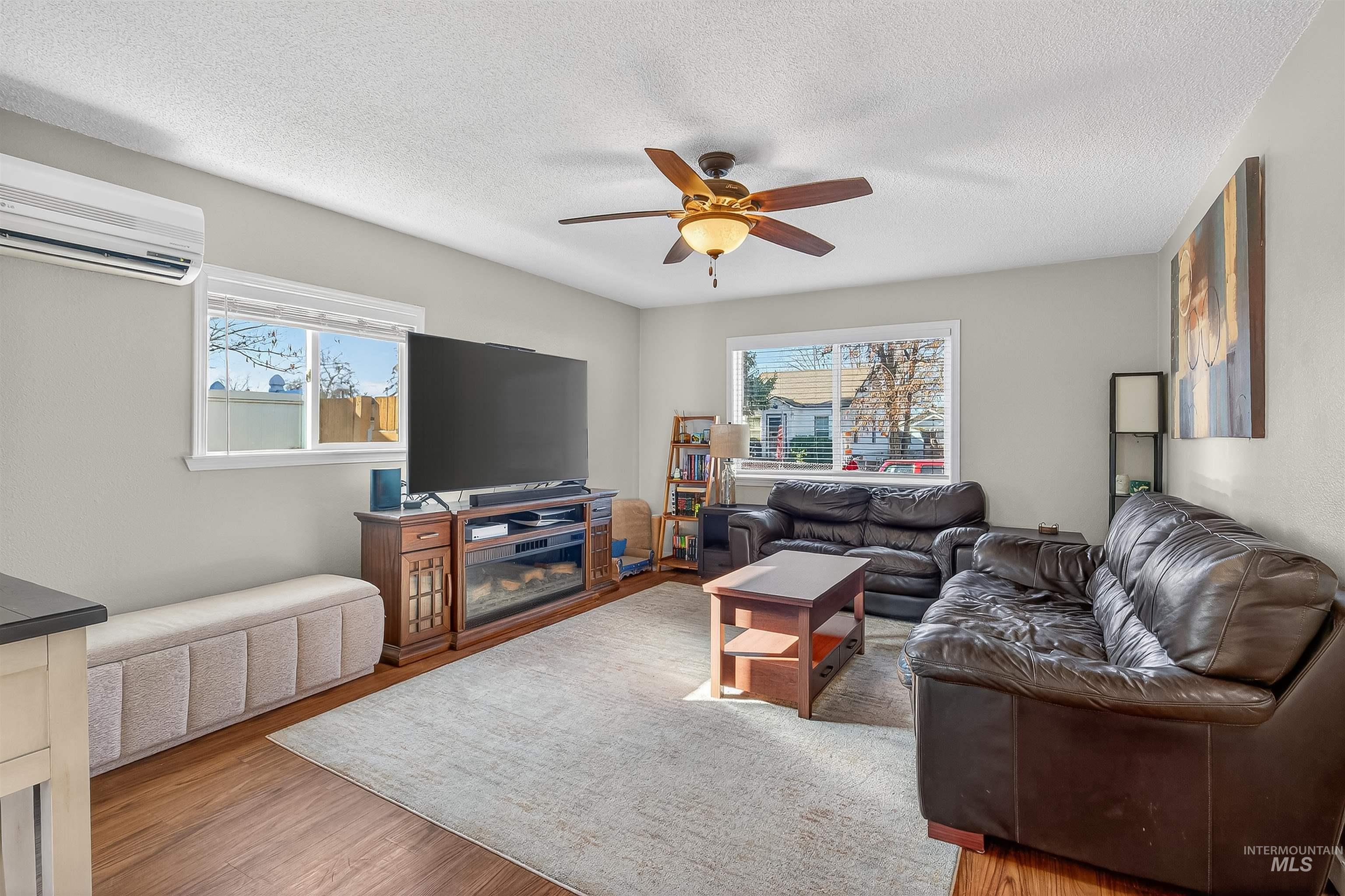 807 3rd Street Clarkston, WA 99403 - Photo 6 of 33 Living area featuring ceiling fan, wood finished floors, and a textured ceiling
