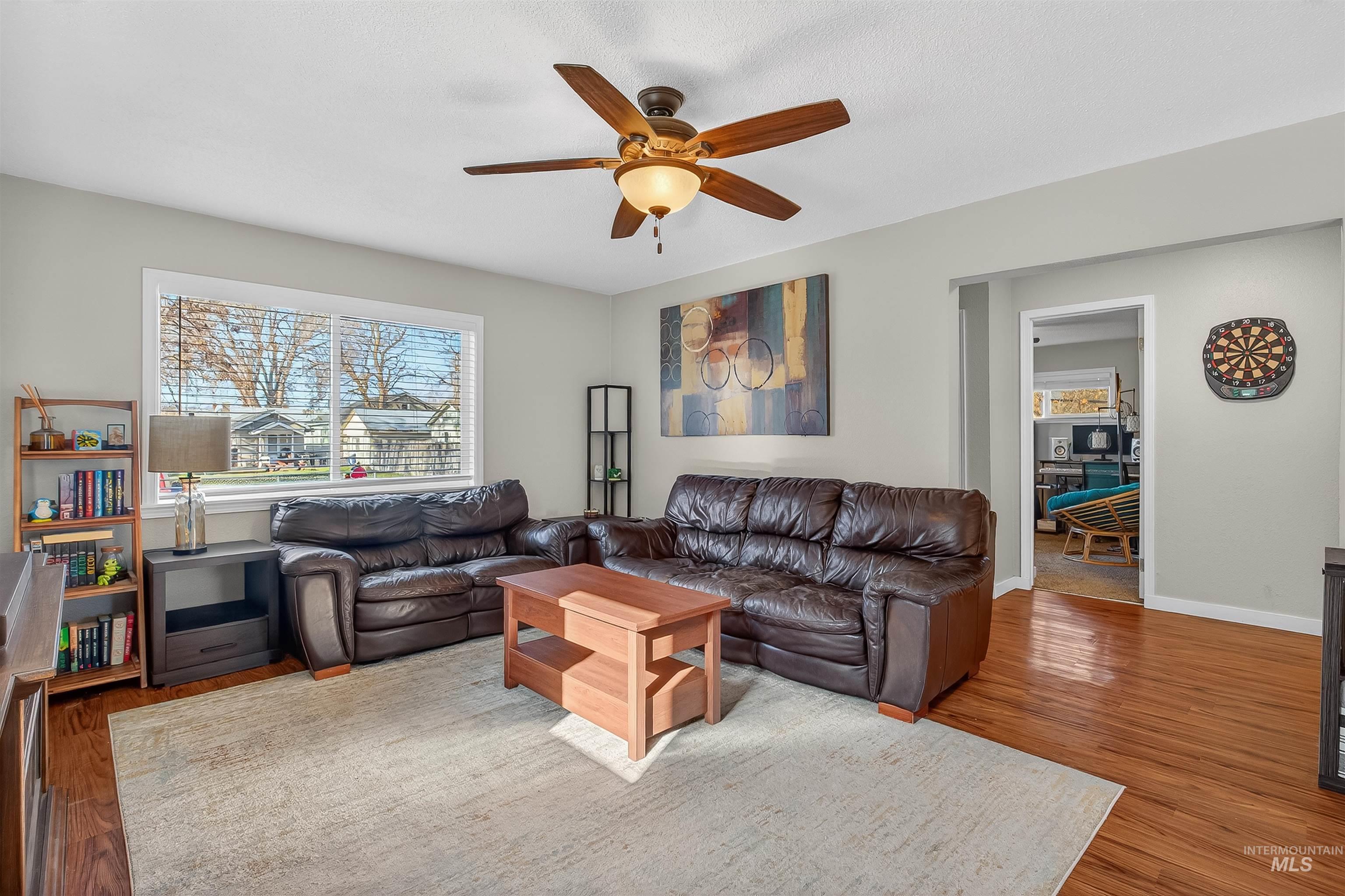 807 3rd Street Clarkston, WA 99403 - Photo 7 of 33 Living area featuring healthy amount of natural light, a ceiling fan, and wood finished floors