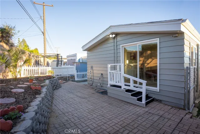 a backyard of a house with table and chairs