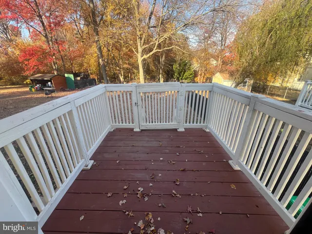 a view of balcony with wooden floor and fence
