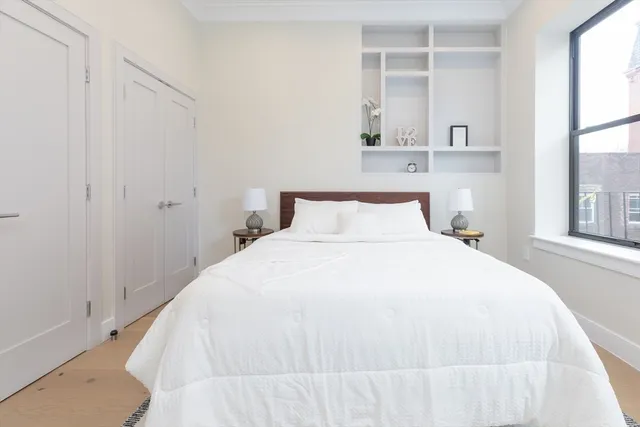 a bedroom with a bed and a window