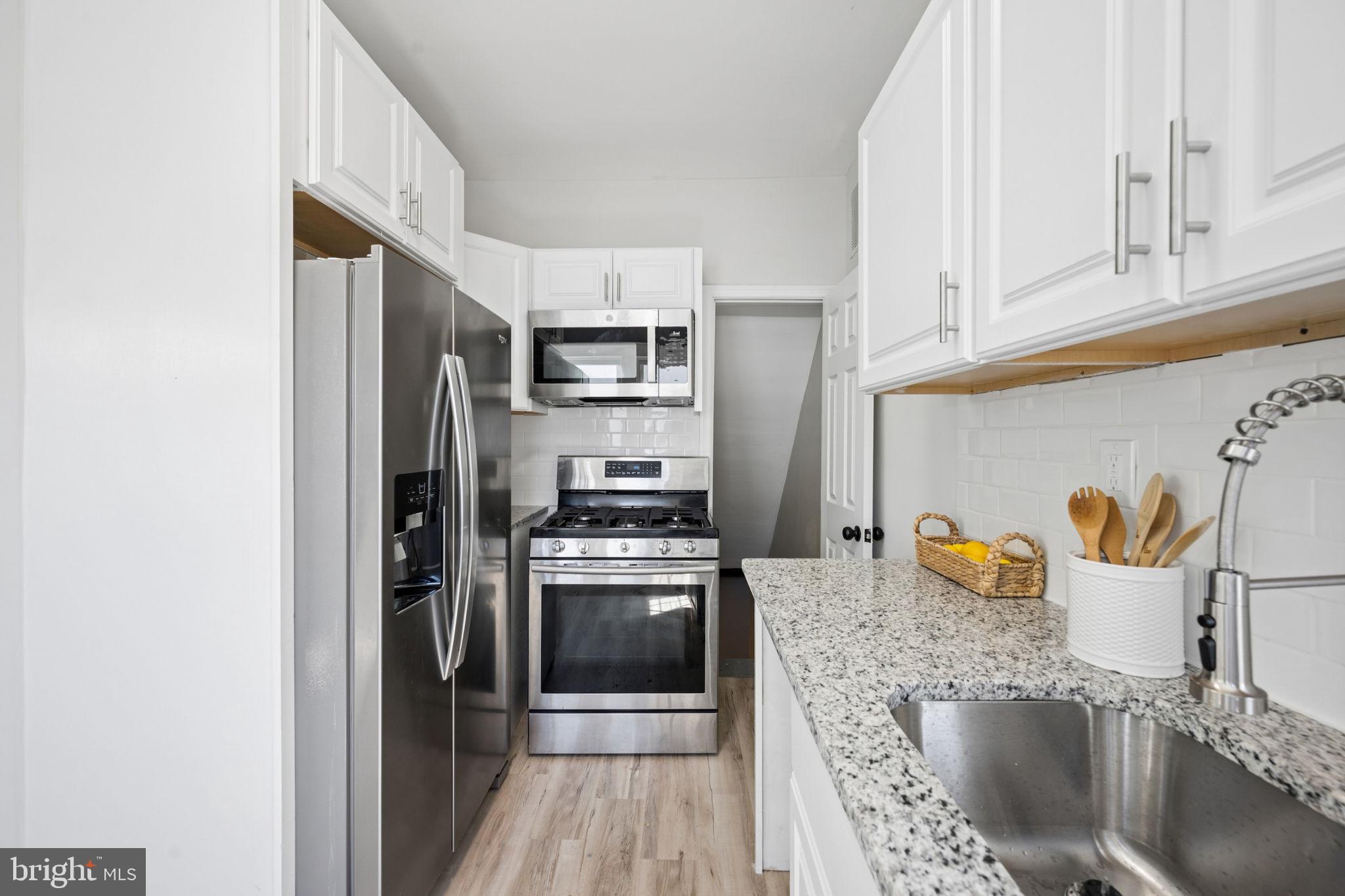 517 Valcour Road Baltimore, MD 21228 - Photo 3 of 47 a kitchen with stainless steel appliances granite countertop a refrigerator and a sink