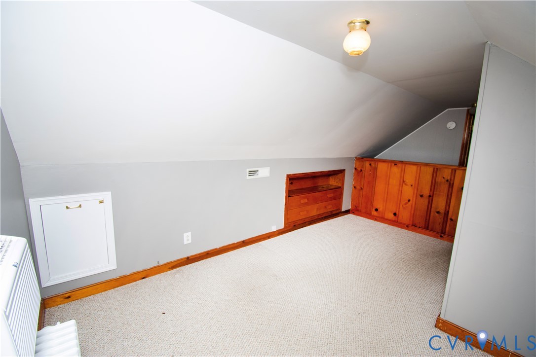 6800 Three Chopt Road Richmond, VA 23226 - Photo 22 of 26 Carpeted room with sloped ceilings, wood-paneled a