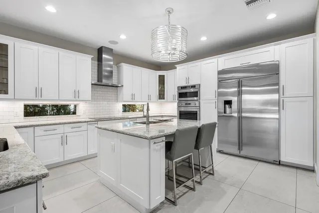 a view of a patio with couches and pool