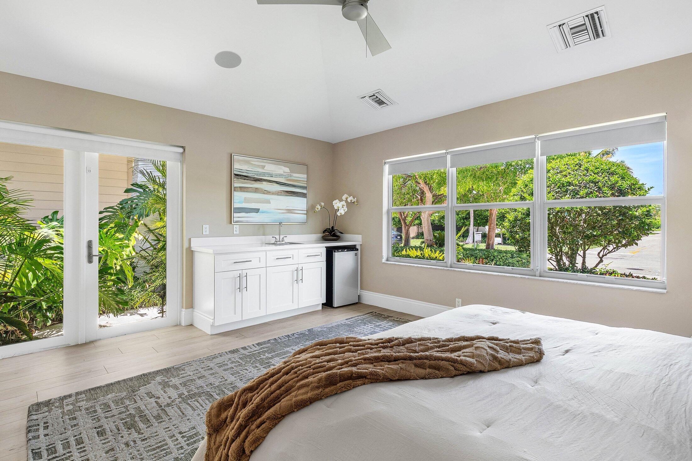1400 Lake Drive Delray Beach, FL 33444 - Photo 31 of 121 a bedroom with a bed and windows