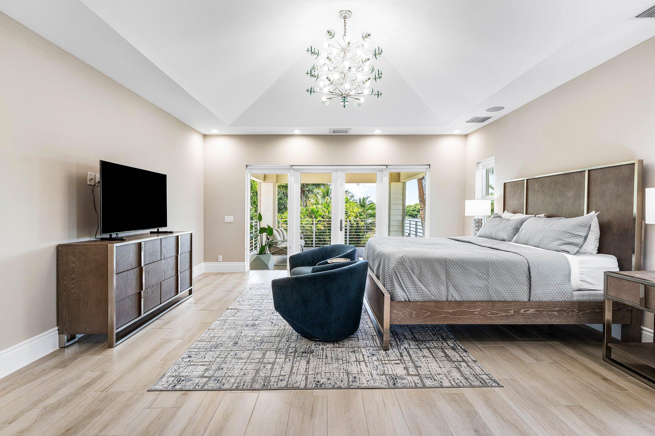 1400 Lake Drive Delray Beach, FL 33444 - Photo 37 of 121 a bedroom with a bed and flat screen tv