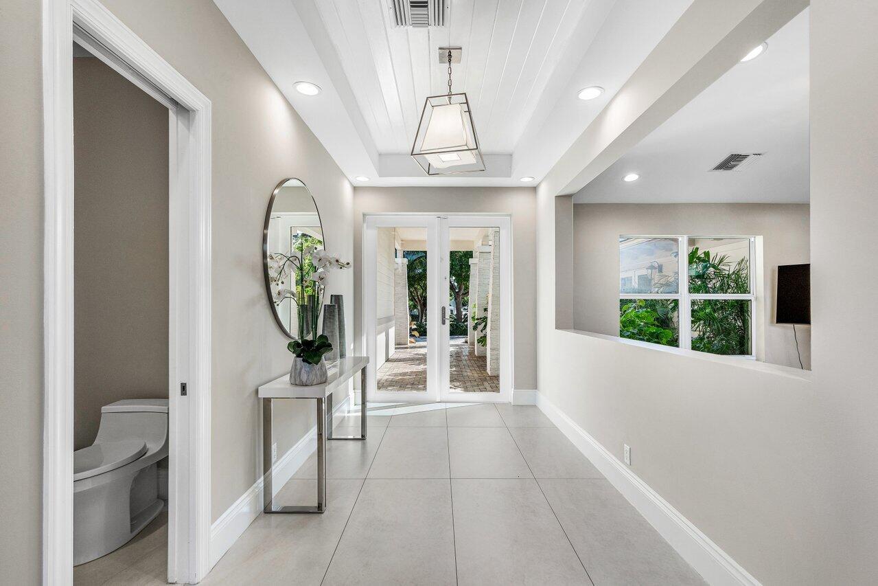 1400 Lake Drive Delray Beach, FL 33444 - Photo 6 of 121 a view of a hallway with furniture and a chandelier