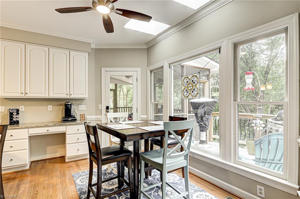 3835 Edgewater Street High Point, NC 27265 - Photo 11 of 30 The breakfast area overlooks the wooded backyard. The kitchen is bright with so much natural light entering the room. Enjoy your morning breakfast and coffee with this peaceful view.