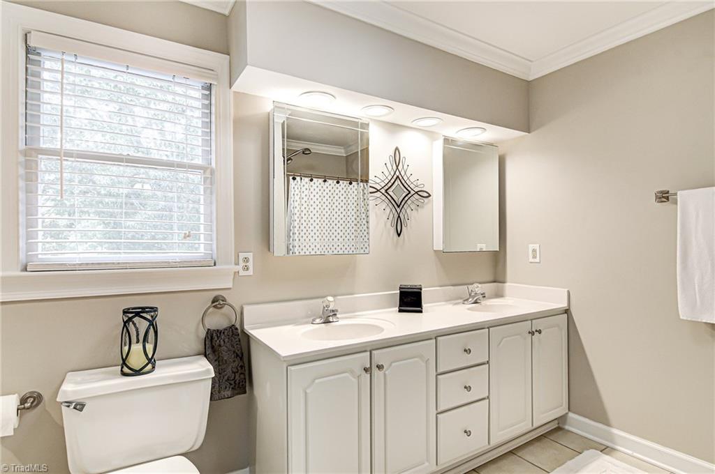 3835 Edgewater Street High Point, NC 27265 - Photo 15 of 30 The master bath has double sinks with a tiled walk-in shower.