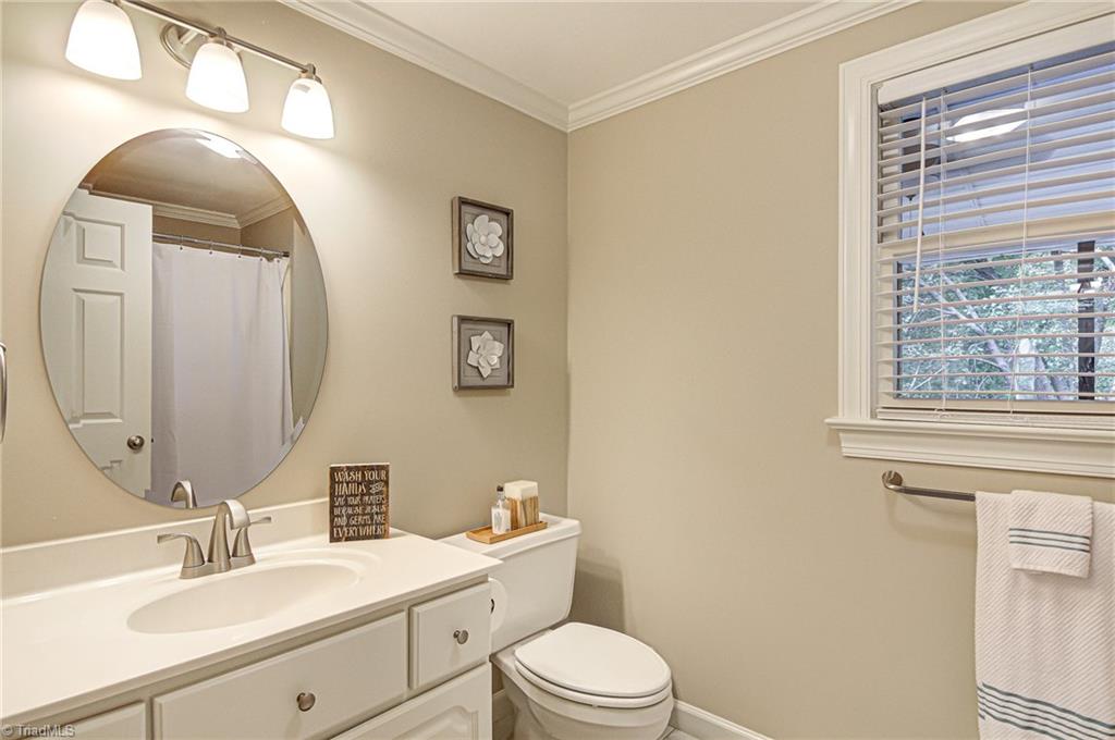 3835 Edgewater Street High Point, NC 27265 - Photo 20 of 30 The guest bath on the second level with a tub and shower combination, neutral coloring and crown molding.