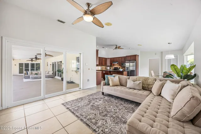 a living room with furniture and kitchen view
