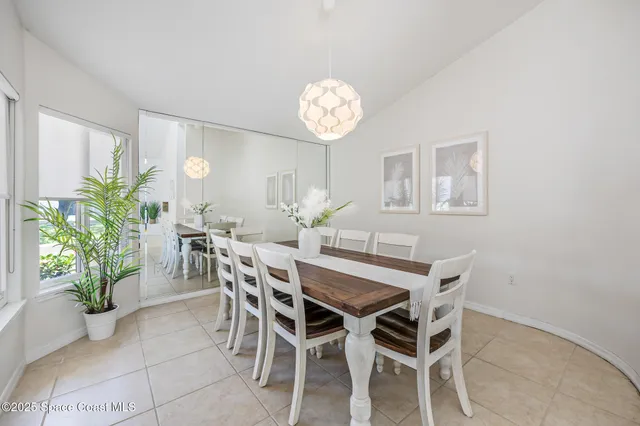 a view of a dining room with furniture and a chandelier