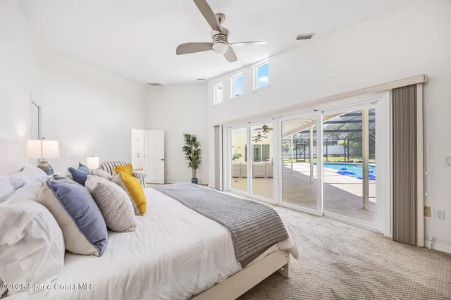 a bedroom with a large bed and a large window