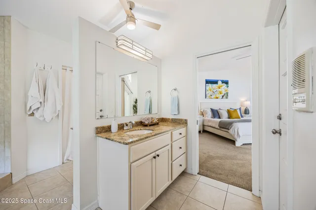 a spacious bathroom with a granite countertop sink and a mirror