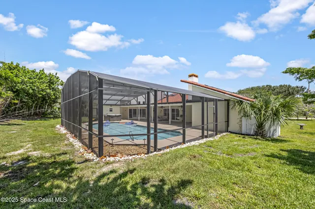 a view of a yard with wooden fence