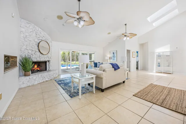 a living room with fireplace chandelier and couches