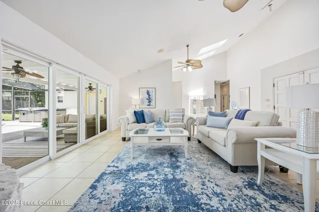 a living room with furniture wooden floor and white walls